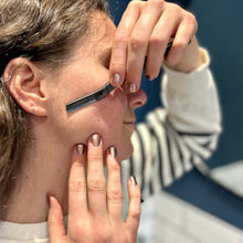 Load image into Gallery viewer, Woman using a matte black metal dermaplaner facial razor - Shoreline Shaving