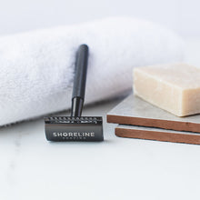 Load image into Gallery viewer, Closeup of matte black metal safety razor with natural shaving soap - Shoreline Shaving
