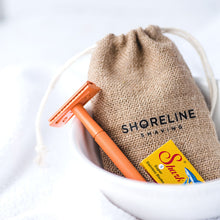 Load image into Gallery viewer, Orange Safety Razor with blades and hessian bag in a white bowl - Shoreline Shaving
