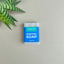 Load image into Gallery viewer, Natural shaving soap on a nude background with a plant in the corner - Shoreline Shaving
