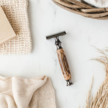 Load image into Gallery viewer, Storm grey bamboo safety razor lay on a flat marbled surface next to shaving soap and soap pouch - Shoreline Shaving