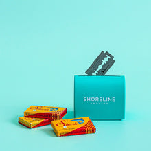 Load image into Gallery viewer, Shark double-edge blades placed beside a razor blade disposal tin - Shoreline Shaving UK