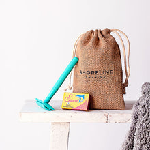 Load image into Gallery viewer, Travel shaving set with reusable teal safety razor, standing on a table - Shoreline Shaving