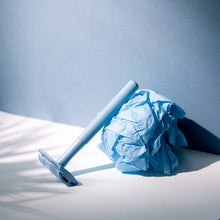 Load image into Gallery viewer, Pale blue reusable safety razor leaning on a blue ball of tissue - Shoreline Shaving