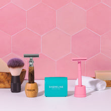 Load image into Gallery viewer, Teal blade disposal tin with a pink safety razor and silver bamboo safety razor standing either side - Shoreline Shaving
