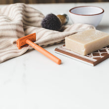 Load image into Gallery viewer, Vivid orange safety razor lay flat with shaving soap and shaving brush - Shoreline Shaving
