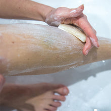 Load image into Gallery viewer, Natural shaving soap bar being applied to a woman&#39;s leg, ready for shaving - Shoreline Shaving
