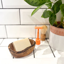 Load image into Gallery viewer, An oval olive wood soap dish with natural soap bar and orange safety razor - Shoreline Shaving
