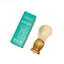 Load image into Gallery viewer, Plastic-free and vegan-friendly shaving brush with wooden handle, lay down next to a teal box for the brush - Shoreline Shaving
