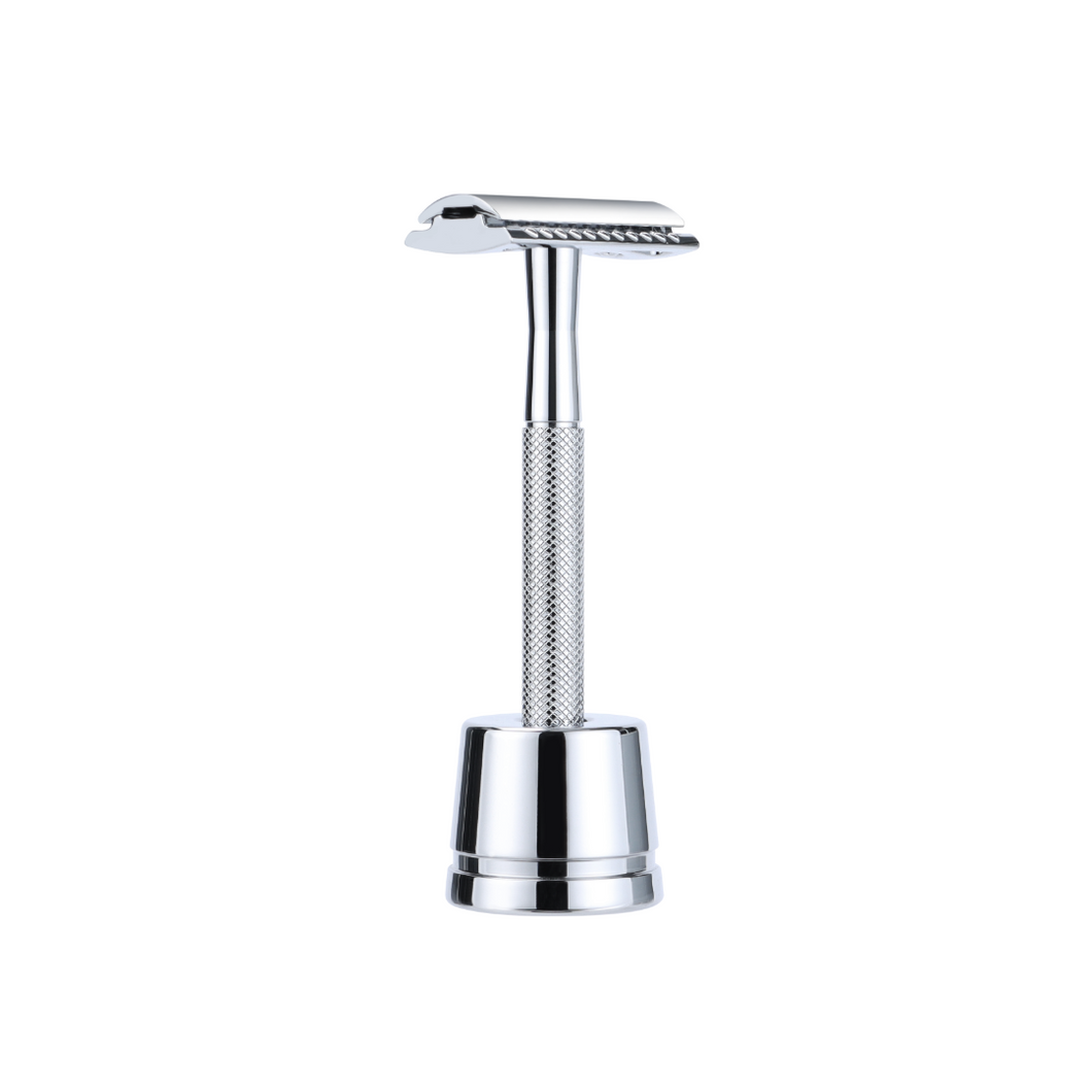 Shiny silver reusable metal safety razor inside a shiny silver razor stand - Shoreline Shaving