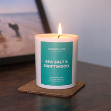 Load image into Gallery viewer, Sea salt &amp; driftwood natural soy wax candle on a brown coaster by Shoreline Shaving
