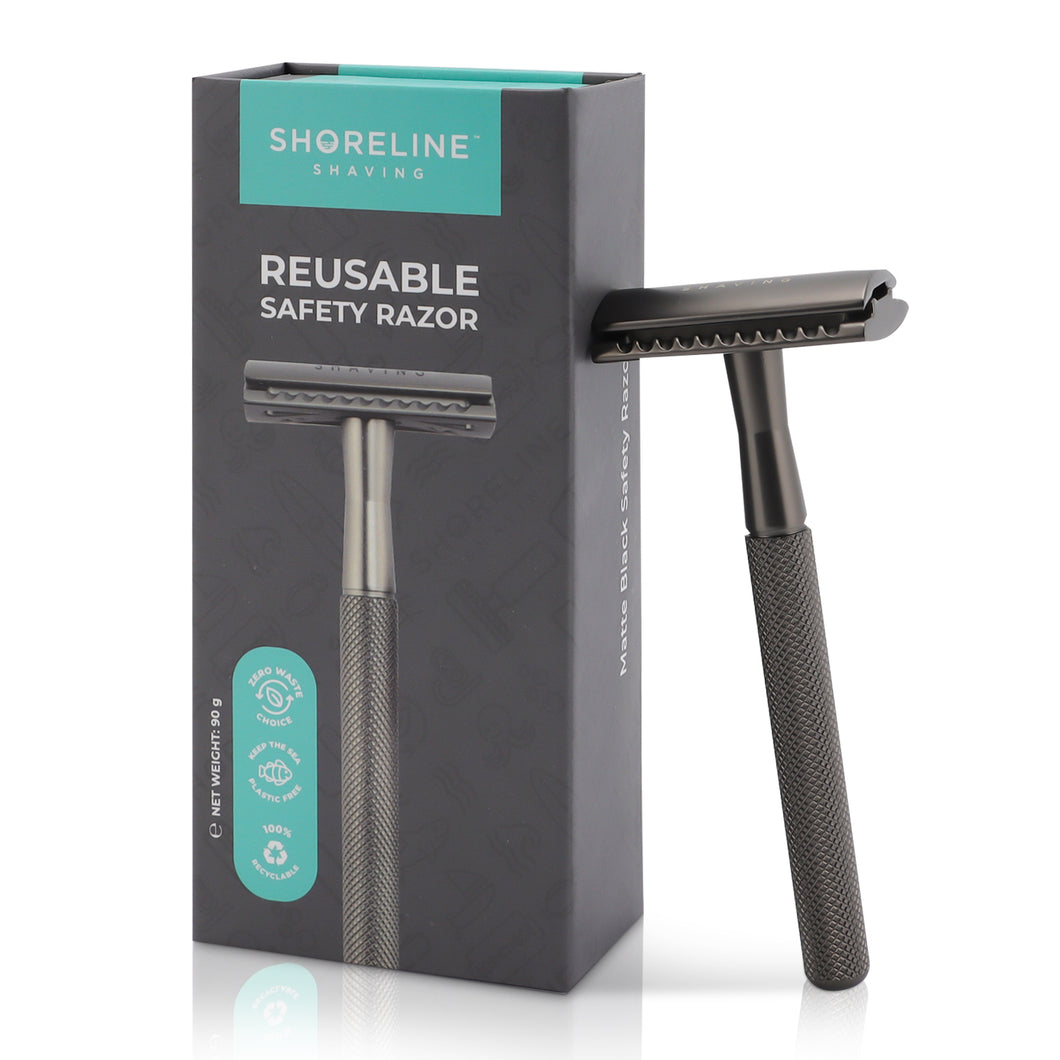 Matte Black safety razor for women & men, leaning upright against the packaging box with a white background - Shoreline Shaving