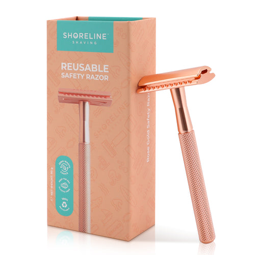 Rose Gold safety razor for women & men, leaning upright against the packaging box with a white background - Shoreline Shaving
