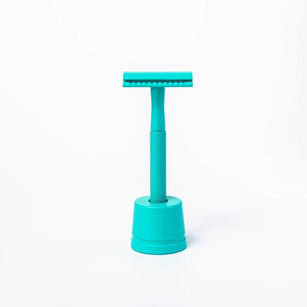 Shoreline teal reusable metal safety razor inside a teal razor stand - Shoreline Shaving