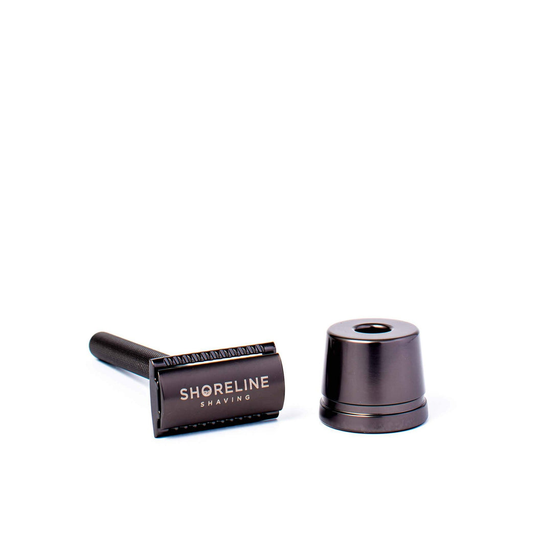 Matte black safety razor next to a black reusable razor stand - Shoreline Shaving