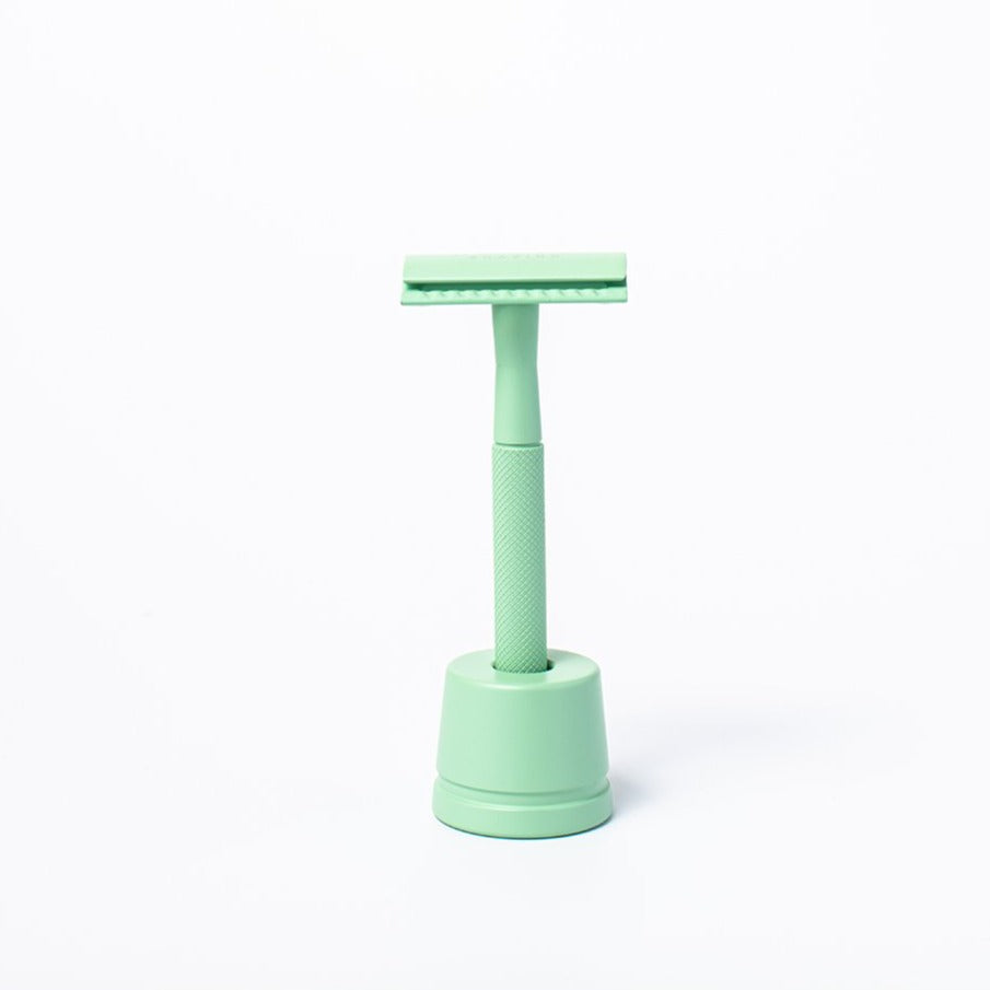 Mint green reusable metal safety razor inside a green razor stand - Shoreline Shaving