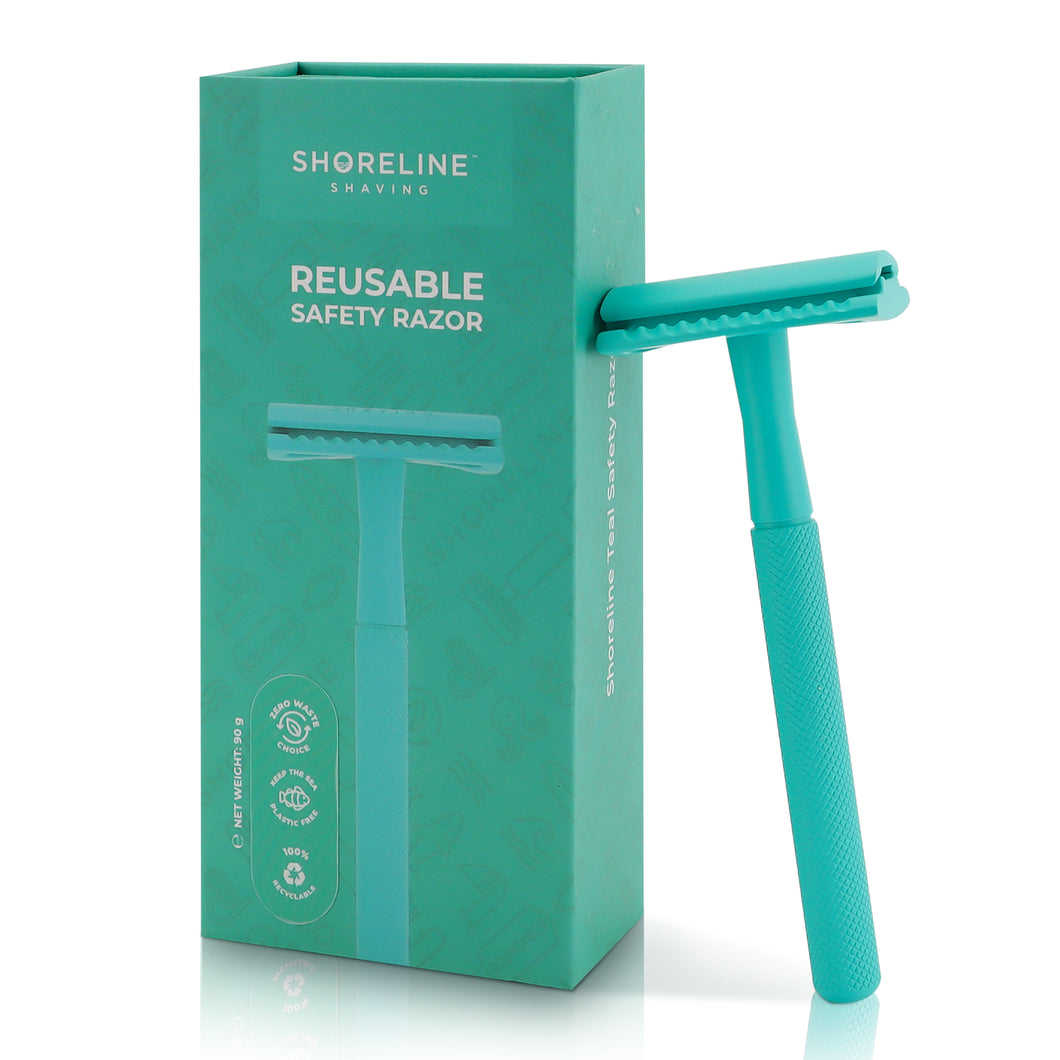 Teal safety razor for women & men, leaning upright against the packaging box with a white background - Shoreline Shaving