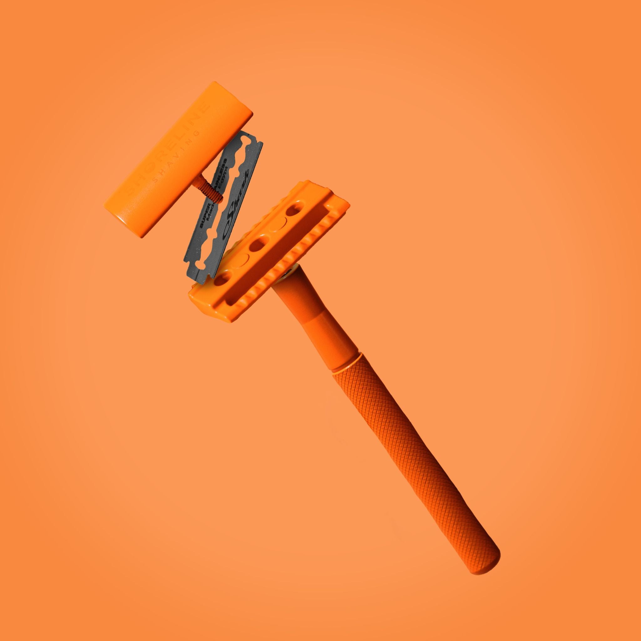 Orange safety razor from an ultimate shaving kit gift set - Shoreline Shaving