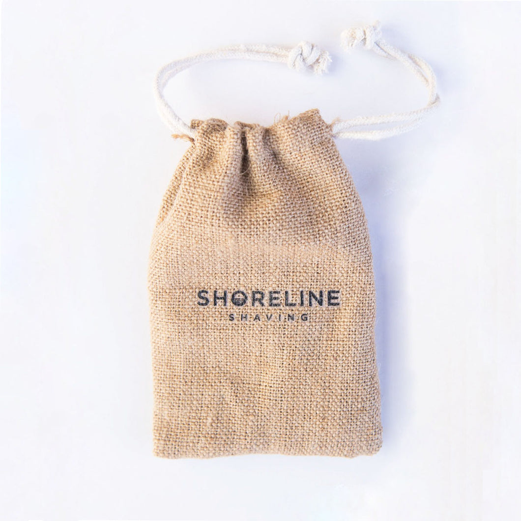 Hessian drawstring travel bag on white background, which is used to carry an eco-friendly safety razor - Shoreline Shaving